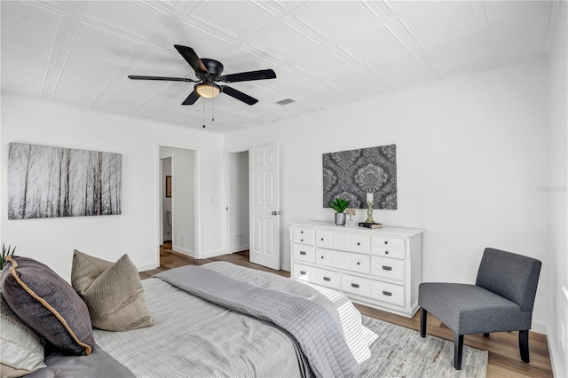 54221 Cravey Rd, Callahan, FL 32011 - bedroom with wood finished floors, ceiling fan, and an ornate ceiling