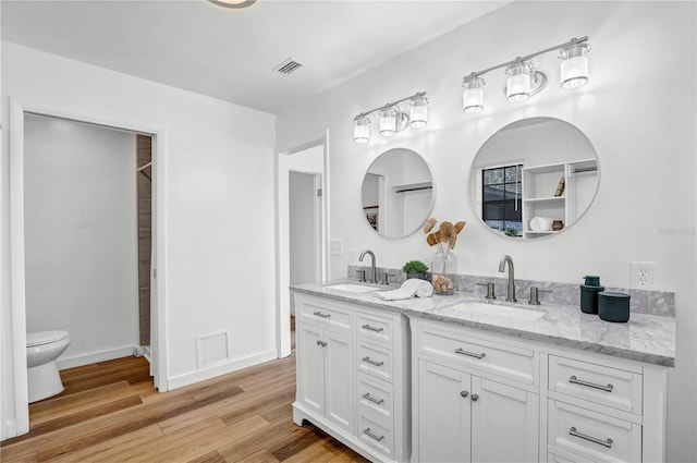 54221 Cravey Rd, Callahan, FL 32011 - bathroom featuring double vanity and wood finished floors