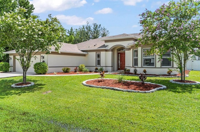 15 Long Pl, Palm Coast, FL 32137 - view of front facade featuring a garage, stucco siding, concrete driveway, a front yard, and roof with shingles