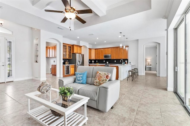 15 Long Pl, Palm Coast, FL 32137 - living room with arched walkways, ceiling fan, light tile patterned floors, wine cooler, and recessed lighting