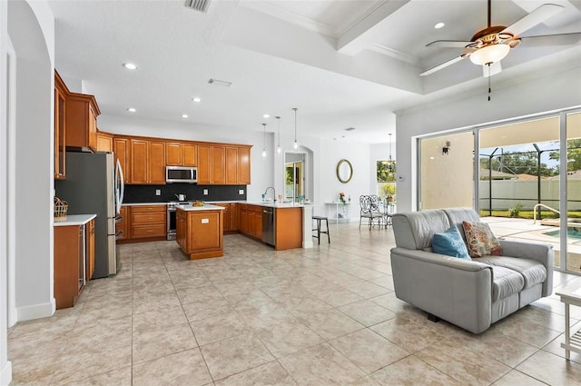 15 Long Pl, Palm Coast, FL 32137 - kitchen featuring open floor plan, stainless steel appliances, a ceiling fan, recessed lighting, and brown cabinets