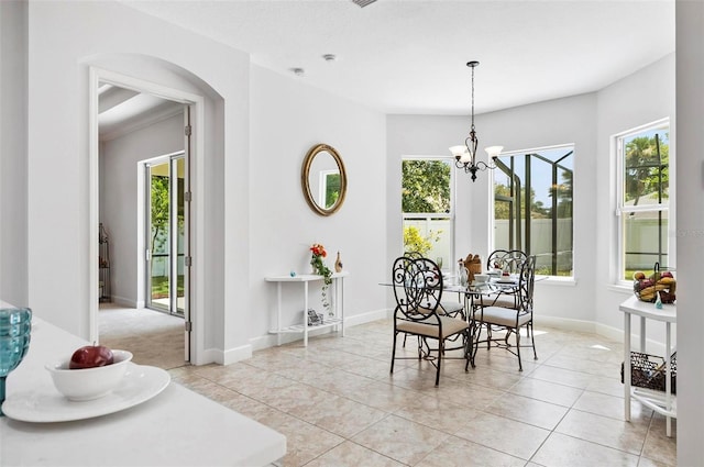 15 Long Pl, Palm Coast, FL 32137 - dining space featuring arched walkways, a chandelier, and light tile patterned floors