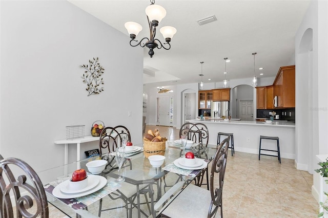 15 Long Pl, Palm Coast, FL 32137 - dining room with arched walkways, a chandelier, and recessed lighting