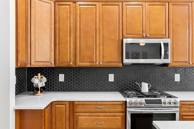 15 Long Pl, Palm Coast, FL 32137 - kitchen with appliances with stainless steel finishes, light countertops, tasteful backsplash, and brown cabinetry