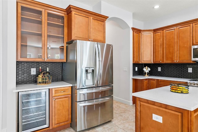15 Long Pl, Palm Coast, FL 32137 - kitchen with appliances with stainless steel finishes, wine cooler, brown cabinets, light countertops, and recessed lighting