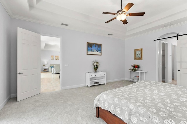 15 Long Pl, Palm Coast, FL 32137 - bedroom with a raised ceiling, a barn door, light carpet, crown molding, and a ceiling fan