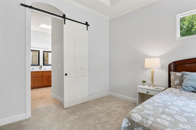 15 Long Pl, Palm Coast, FL 32137 - bedroom featuring a barn door, light carpet, ornamental molding, and ensuite bathroom