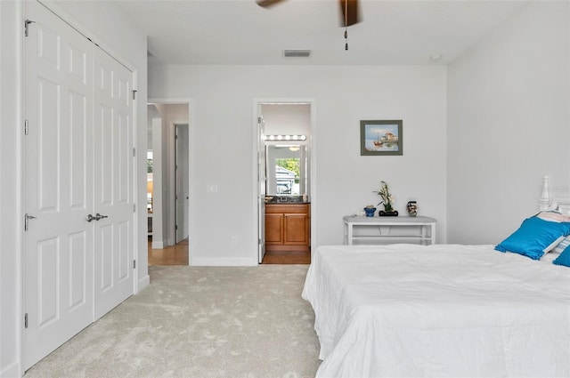 15 Long Pl, Palm Coast, FL 32137 - bedroom with carpet flooring, a closet, ensuite bathroom, and ceiling fan