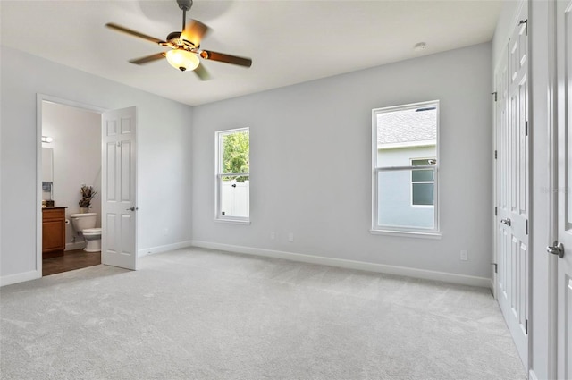 15 Long Pl, Palm Coast, FL 32137 - unfurnished bedroom featuring light colored carpet, connected bathroom, and a ceiling fan