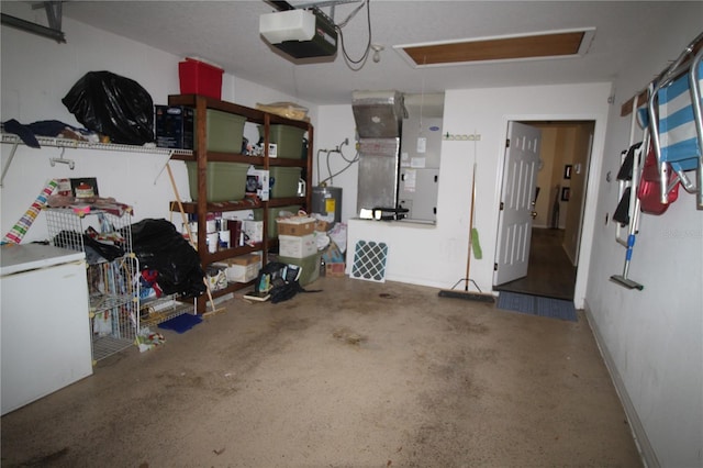 07 Gaston Pl, Palm Coast, FL 32164 - garage featuring a garage door opener, freestanding refrigerator, electric water heater, and heating unit