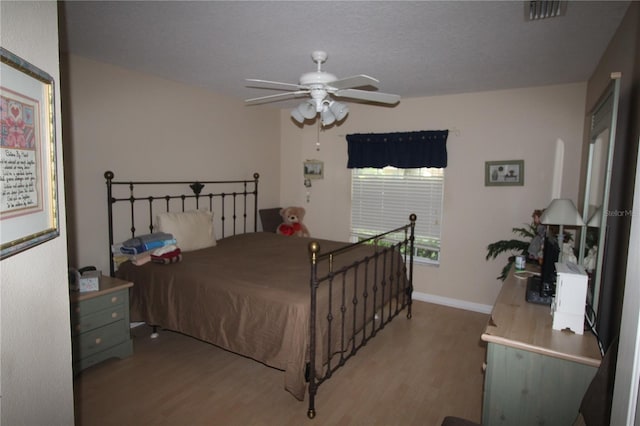 07 Gaston Pl, Palm Coast, FL 32164 - bedroom with wood finished floors and a ceiling fan