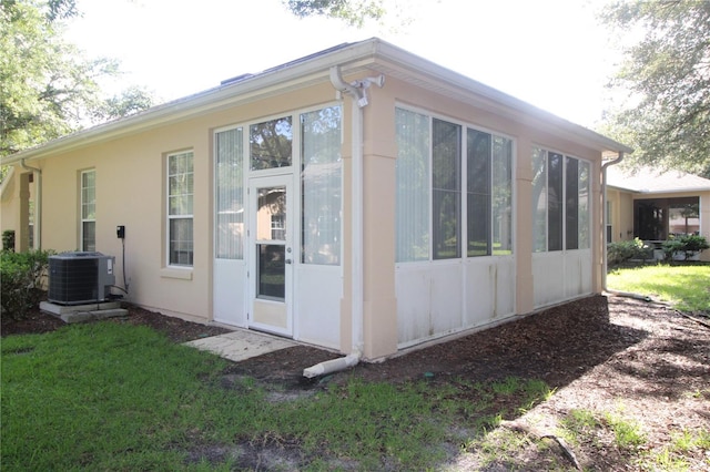 07 Gaston Pl, Palm Coast, FL 32164 - view of home's exterior with a cooling unit and a sunroom