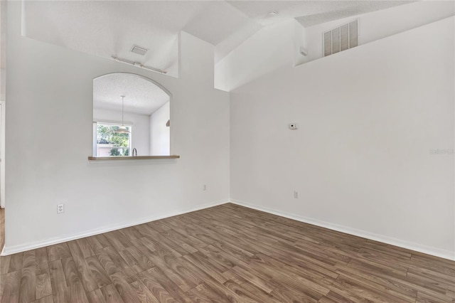 112 Ulaturn Trl, Palm Coast, FL 32164 - spare room with wood finished floors and arched walkways