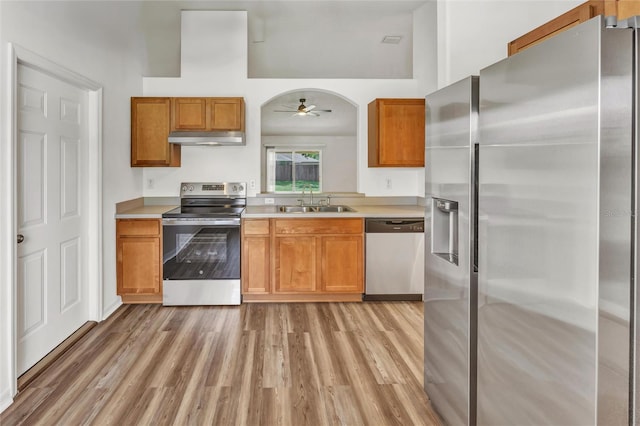 112 Ulaturn Trl, Palm Coast, FL 32164 - kitchen featuring appliances with stainless steel finishes, under cabinet range hood, a ceiling fan, and light wood-style floors