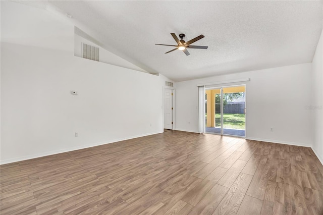 112 Ulaturn Trl, Palm Coast, FL 32164 - unfurnished room with a ceiling fan, wood finished floors, vaulted ceiling, and a textured ceiling