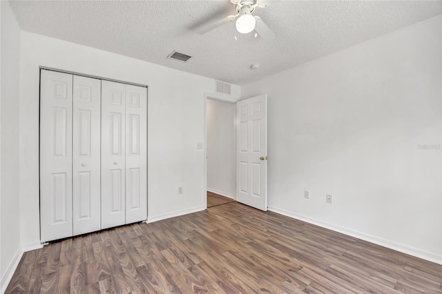 112 Ulaturn Trl, Palm Coast, FL 32164 - unfurnished bedroom featuring wood finished floors, a textured ceiling, a closet, and ceiling fan