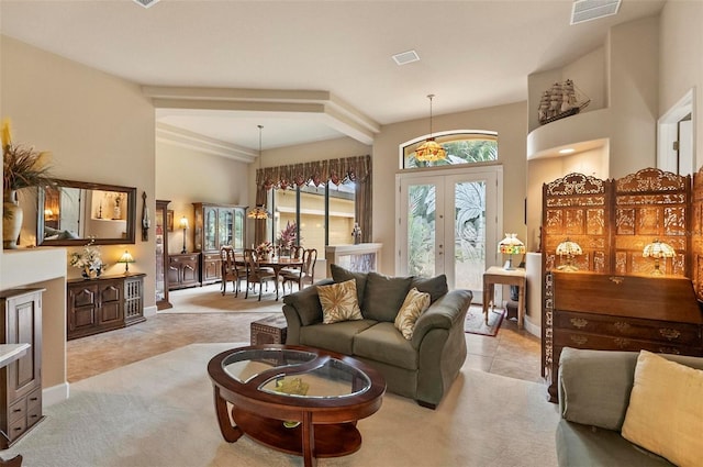 23 Creekside Dr, Palm Coast, FL 32137 - living room featuring french doors, light tile patterned floors, light colored carpet, and a towering ceiling