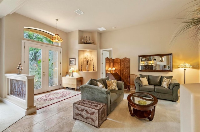 23 Creekside Dr, Palm Coast, FL 32137 - tiled living room with french doors, high vaulted ceiling, and carpet floors