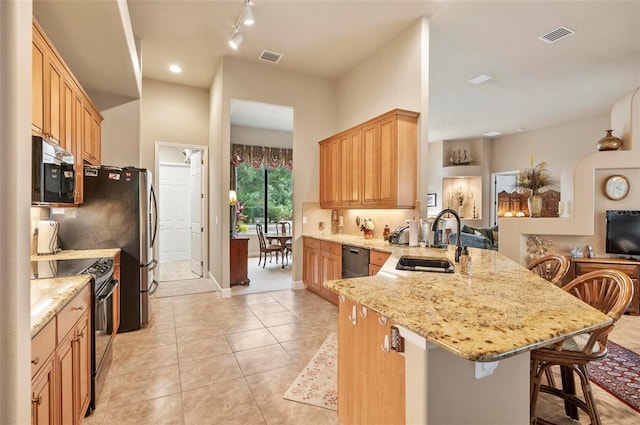 23 Creekside Dr, Palm Coast, FL 32137 - kitchen featuring electric range, stainless steel microwave, a peninsula, dishwasher, and a kitchen breakfast bar