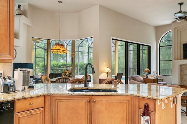 23 Creekside Dr, Palm Coast, FL 32137 - kitchen featuring light stone counters, black dishwasher, a ceiling fan, open floor plan, and a peninsula