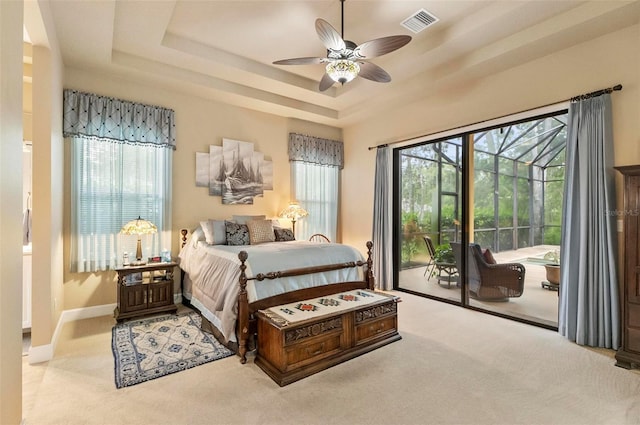 23 Creekside Dr, Palm Coast, FL 32137 - bedroom with access to exterior, a tray ceiling, carpet flooring, and a ceiling fan