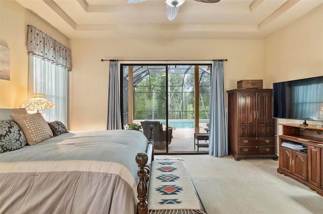 23 Creekside Dr, Palm Coast, FL 32137 - bedroom with a tray ceiling, light colored carpet, access to exterior, and a ceiling fan