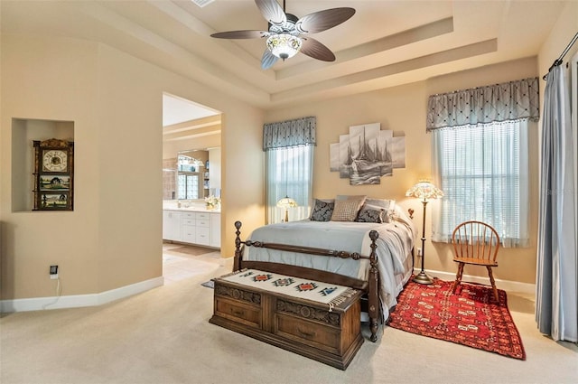 23 Creekside Dr, Palm Coast, FL 32137 - carpeted bedroom featuring a raised ceiling, ensuite bath, and ceiling fan