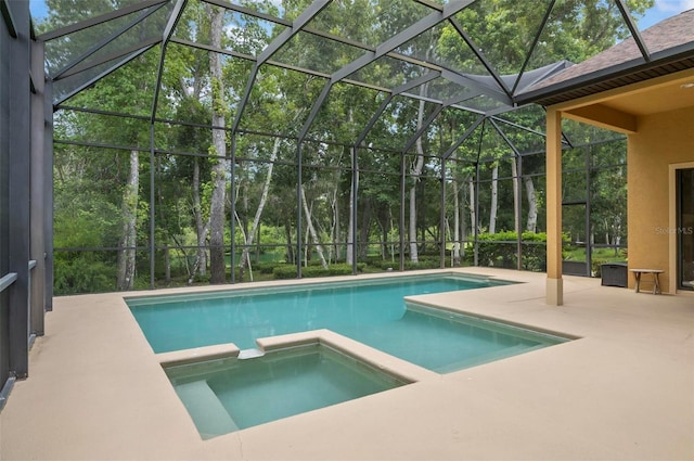 23 Creekside Dr, Palm Coast, FL 32137 - view of swimming pool featuring a pool with connected hot tub, a patio area, glass enclosure, and view of wooded area