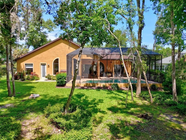23 Creekside Dr, Palm Coast, FL 32137 - rear view of property featuring stucco siding, a yard, an outdoor pool, and a lanai