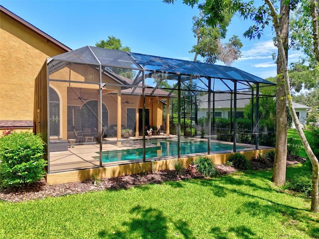23 Creekside Dr, Palm Coast, FL 32137 - back of house with a ceiling fan, stucco siding, a yard, an outdoor pool, and a patio area