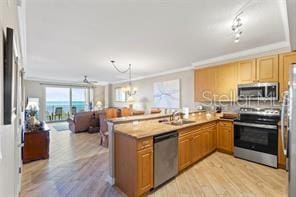 80 Surfview Dr Unit 408, Palm Coast, FL 32137 - kitchen featuring open floor plan, ornamental molding, a peninsula, light wood-style floors, and stainless steel appliances
