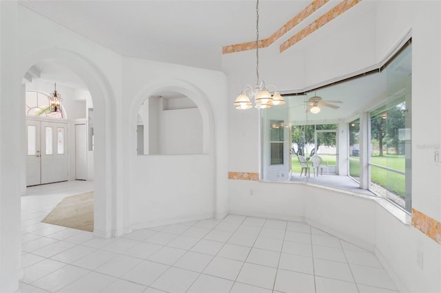16 Birchwood Pl, Palm Coast, FL 32137 - tiled spare room with a chandelier, arched walkways, and a ceiling fan