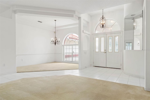 16 Birchwood Pl, Palm Coast, FL 32137 - carpeted entrance foyer with a chandelier and tile patterned floors
