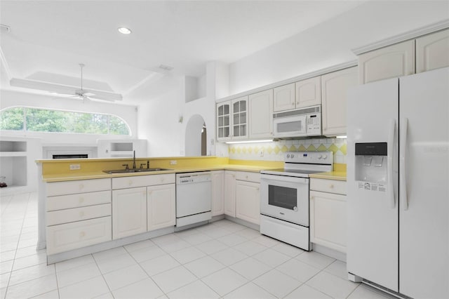 16 Birchwood Pl, Palm Coast, FL 32137 - kitchen featuring white appliances, a peninsula, tasteful backsplash, a ceiling fan, and glass insert cabinets