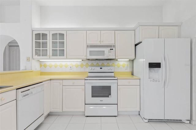 16 Birchwood Pl, Palm Coast, FL 32137 - kitchen with white appliances, light countertops, glass insert cabinets, tasteful backsplash, and white cabinets