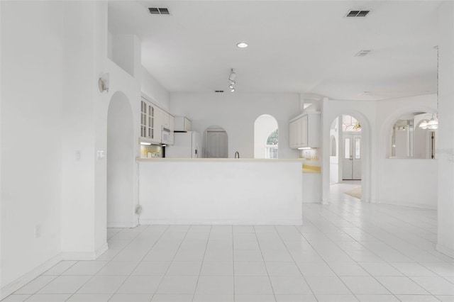 16 Birchwood Pl, Palm Coast, FL 32137 - unfurnished living room with arched walkways and recessed lighting