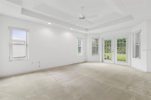 16 Birchwood Pl, Palm Coast, FL 32137 - carpeted empty room with a tray ceiling, french doors, a ceiling fan, and recessed lighting