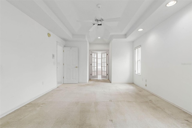 16 Birchwood Pl, Palm Coast, FL 32137 - spare room featuring a tray ceiling, recessed lighting, ceiling fan, and light carpet