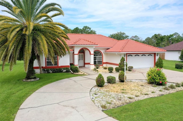 16 Birchwood Pl, Palm Coast, FL 32137 - mediterranean / spanish house with driveway, an attached garage, a front lawn, stucco siding, and a tile roof