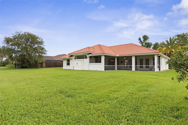 16 Birchwood Pl, Palm Coast, FL 32137 - back of property featuring a sunroom, a lawn, french doors, and a tile roof