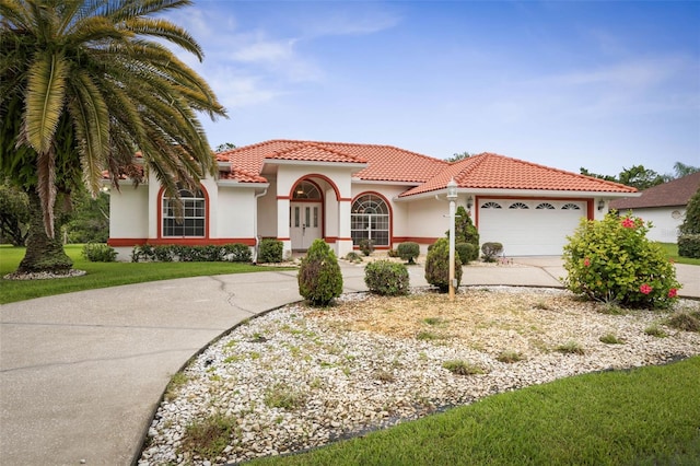 16 Birchwood Pl, Palm Coast, FL 32137 - mediterranean / spanish house featuring driveway, stucco siding, a garage, and a tiled roof