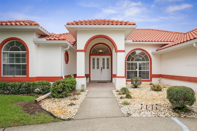 16 Birchwood Pl, Palm Coast, FL 32137 - property entrance with a tiled roof and stucco siding