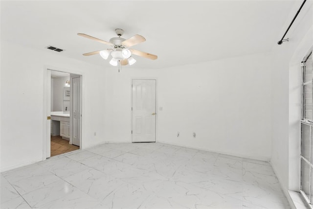 2790 Pelham Cir, Deltona, FL 32738 - unfurnished bedroom featuring light marble finish flooring, a ceiling fan, and ensuite bathroom