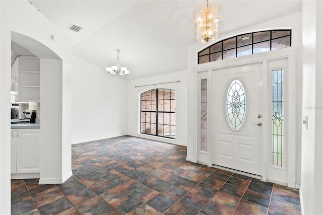 2790 Pelham Cir, Deltona, FL 32738 - foyer with a chandelier, plenty of natural light, stone finish floors, and arched walkways