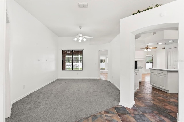 2790 Pelham Cir, Deltona, FL 32738 - empty room with a ceiling fan, arched walkways, and healthy amount of natural light