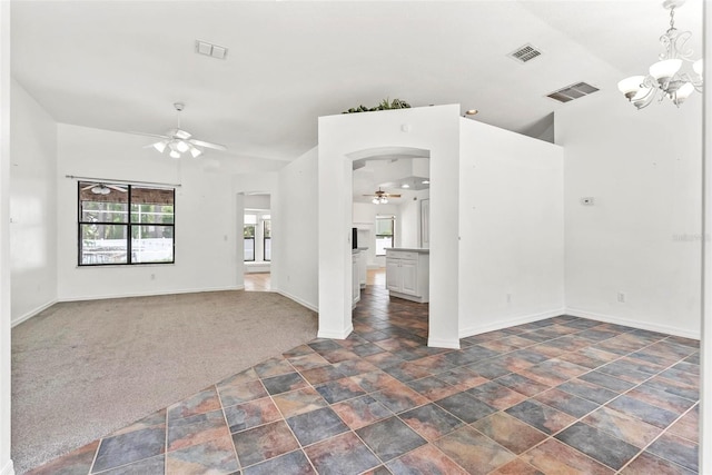 2790 Pelham Cir, Deltona, FL 32738 - empty room featuring a ceiling fan, stone finish flooring, a chandelier, arched walkways, and dark carpet