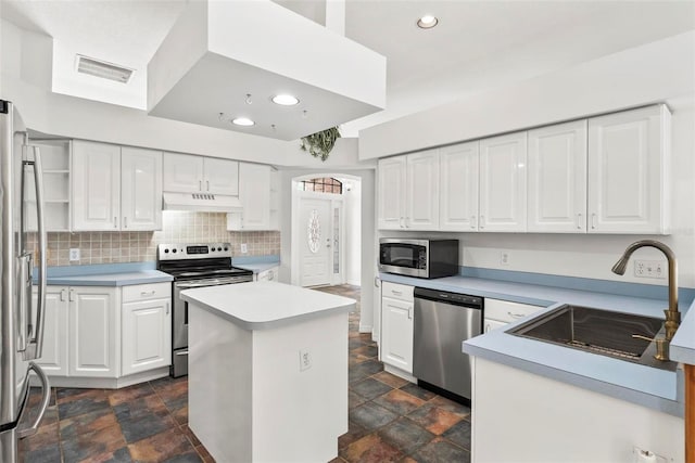 2790 Pelham Cir, Deltona, FL 32738 - kitchen with stainless steel appliances, under cabinet range hood, stone finish flooring, white cabinets, and recessed lighting