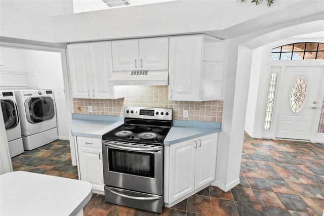 2790 Pelham Cir, Deltona, FL 32738 - kitchen featuring custom range hood, washing machine and dryer, stainless steel range with electric stovetop, light countertops, and stone finish floors