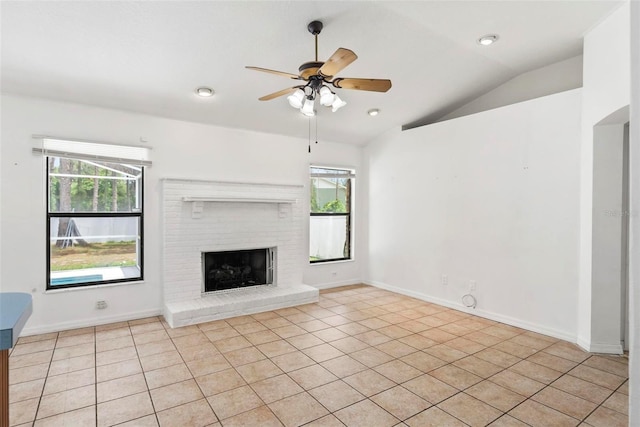 2790 Pelham Cir, Deltona, FL 32738 - unfurnished living room featuring lofted ceiling, healthy amount of natural light, ceiling fan, light tile patterned floors, and a fireplace