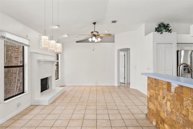 2790 Pelham Cir, Deltona, FL 32738 - unfurnished living room featuring a ceiling fan, arched walkways, a fireplace, light tile patterned floors, and recessed lighting